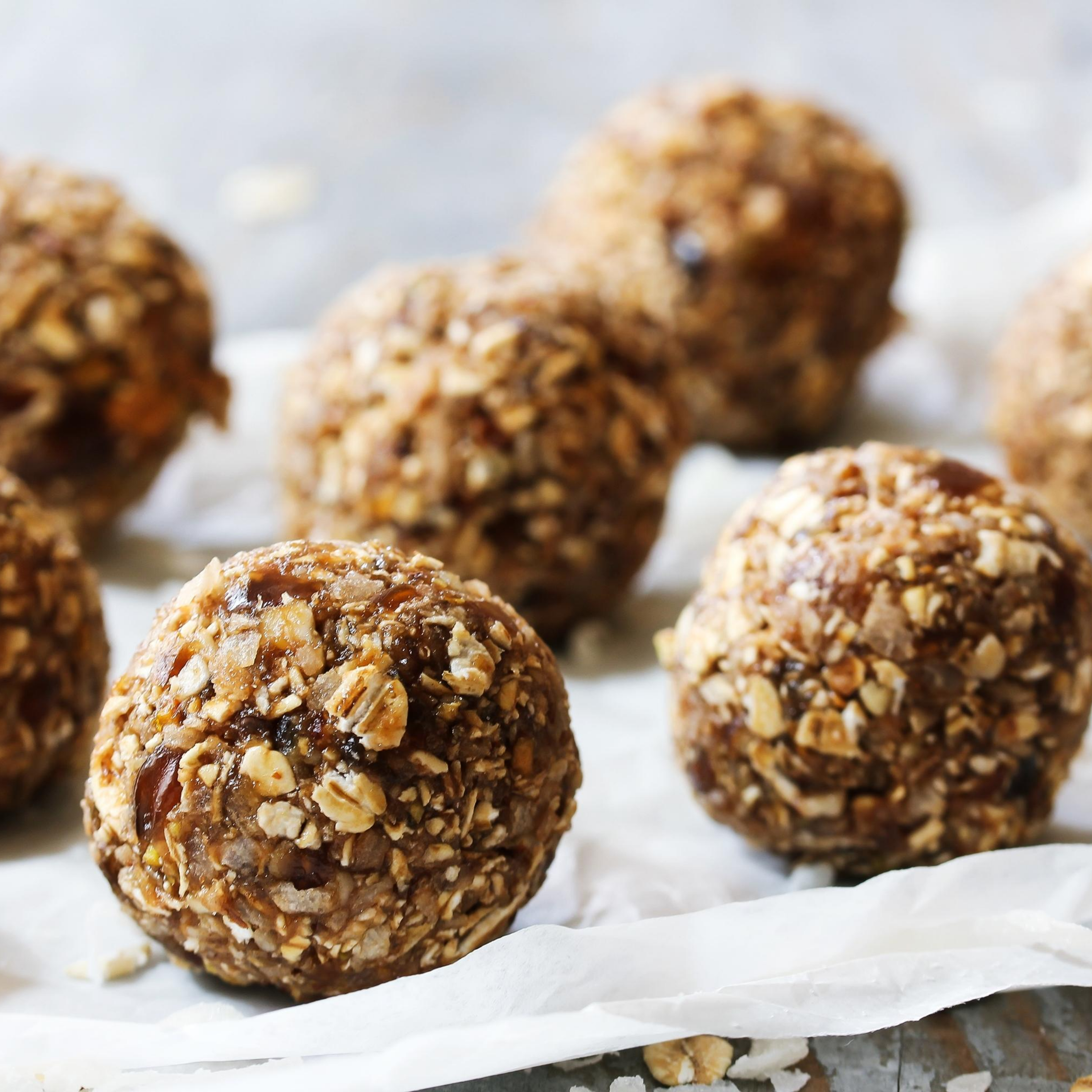 Brown energy oat balls on white baking sheet, represents “Dorm Room Friendly Protein Packed Recipes” program